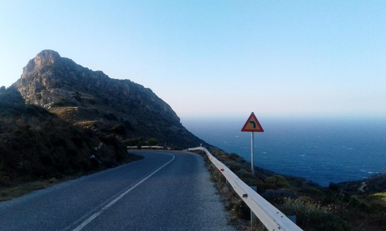 Road with left-turn-sign on Naxos, near Mesi